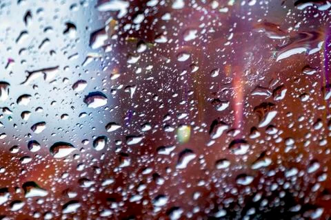 Drops reflected in the window with colorful reflections 스톡 사진