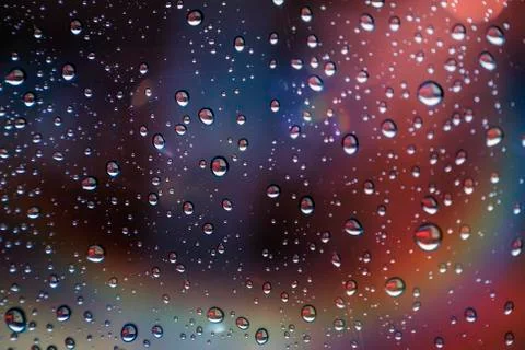 Drops reflected in the window with colorful reflections 스톡 사진
