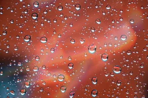 Drops reflected in the window with colorful reflections 스톡 사진