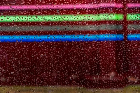 Drops reflected in the window with colorful reflections 스톡 사진