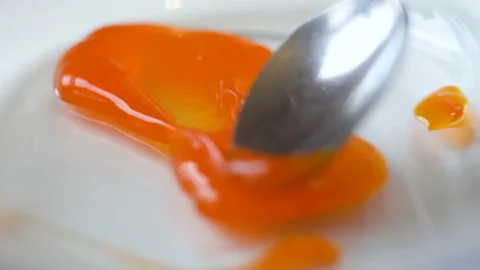 Drops of sauce interfere with a spoon. macro 4K Stock Footage 128153797