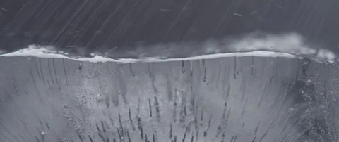 Drops of shallow water fall on the surface of the ice cube Stock Footage 106007139