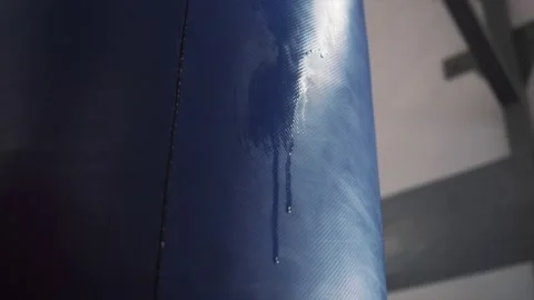 Drops of sweat trickle down the boxing bag Stock Footage 221125215