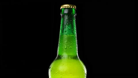 Drops trickle down the beer bottle. Cold and fresh beer bottle  Stock Footage 153276960