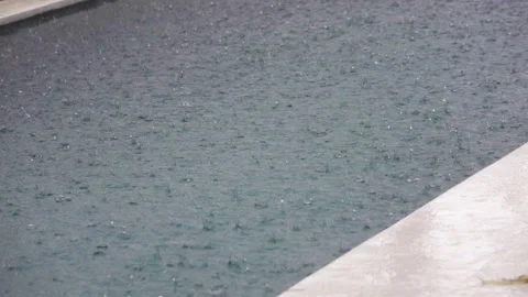Drops of a tropical rain fall in water,Slow motion Stock Footage 102946141