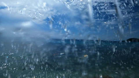 Drops of water from a beach shower fly in different directions Vidéo 257306440