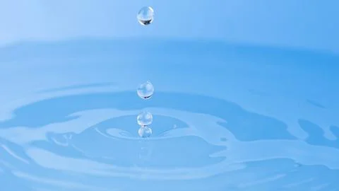 Drops of water on a blue background. Stock Photos