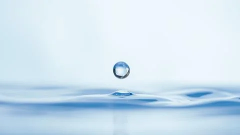 Drops of water on a blue background. Stock Photos