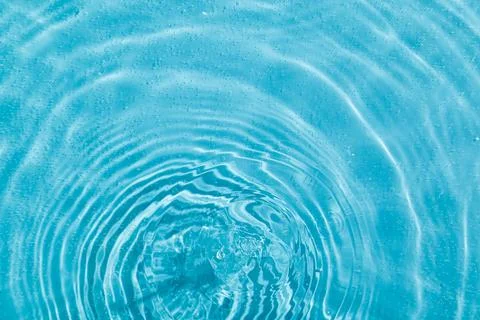 Drops on water with circles on a blue background Stock Illustration