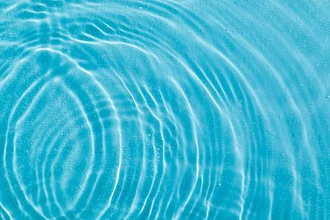 Drops on water with circles on a blue background Stock Photos