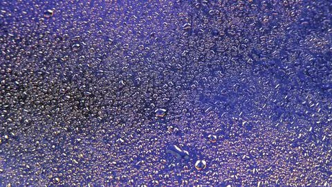Drops of water on a colored background. Abstract texture Stock Photos