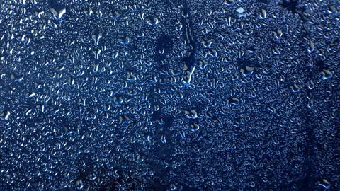 Drops of water on a colored background. Abstract texture Stock Photos