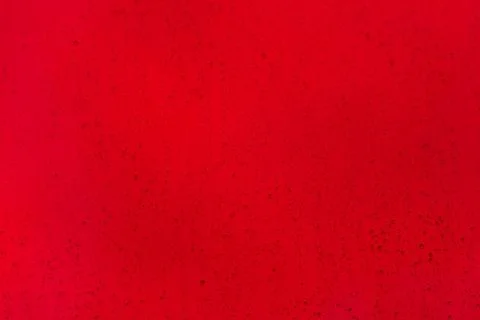 Drops of water of different size on a red background. Stock Photos