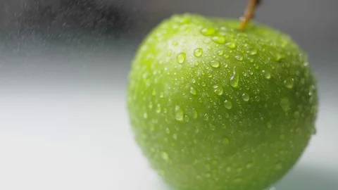 Drops of water drip down the surface of the apple. Food video Stock Footage 89368668