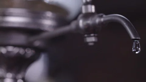 Drops of water drip from the tap for absent. Close-up Stock Footage 129008223