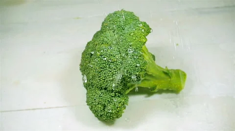 Drops of water dripping on broccoli. Slow motion. Stock Footage 57556290