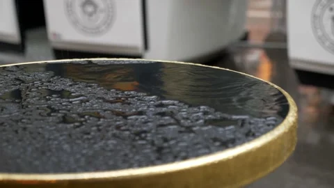 Drops of water fall on a black coffee table. Rainy day. Slow motion 4K Video stock 178512776