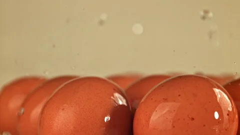 Drops of water fall on chicken eggs. Filmed on a high-speed camera at 1000 fps. Stock-Footage 322741538