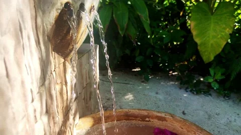 Drops of water fall down. Water pouring down into a bowl. Stock Footage 162343508