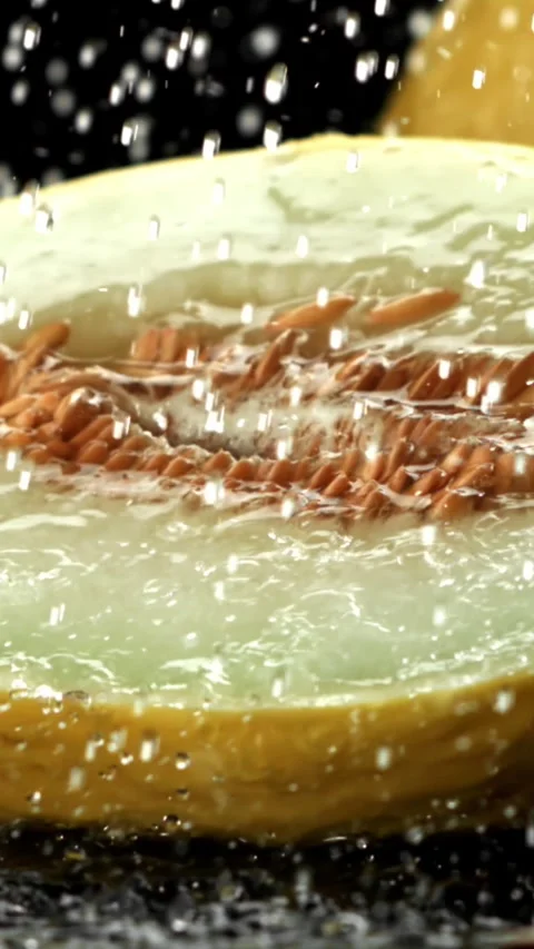 Drops of water fall on a fresh melon. Filmed on a high-speed camera at 1000 fps Stock Footage 335371560