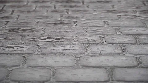 Drops of water fall on a grey paved surface, Close-Up Stock Footage 121376549