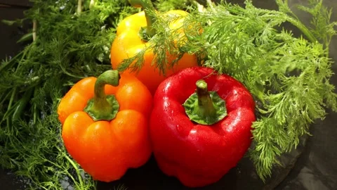 Drops of water fall on peppers Stock Footage 236978530