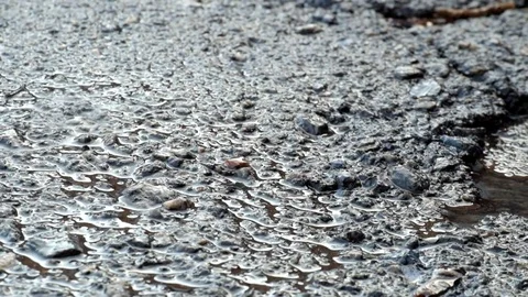Drops of water falling on asphalt Stock Footage 83132540