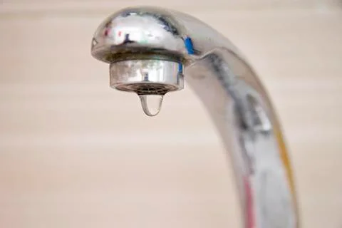 Drops of water falling down from the crane Stock Photos