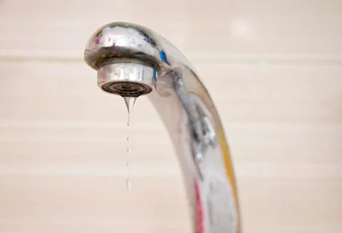 Drops of water falling down from the crane Stock Photos