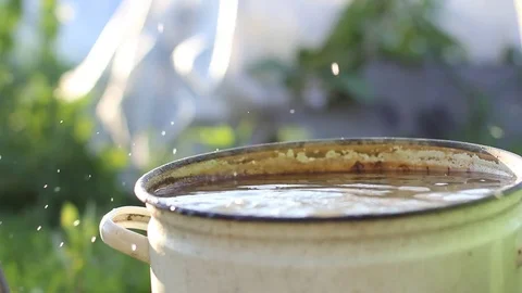 Drops of water falling into the pan Stock Footage 77759683