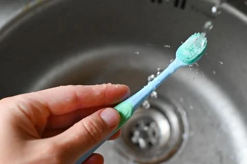 Drops of water falling on a toothbrush Stock Photos