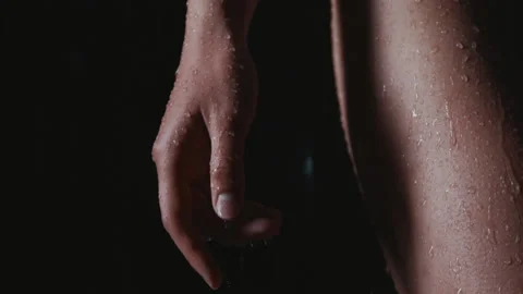 Drops of water flow down female hands and hips close up. Young woman gets wet in Stock Footage 144147008