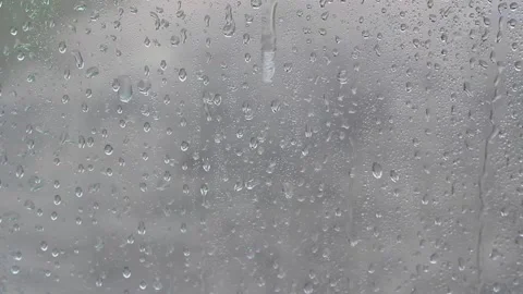 Drops of water flow down the gray glass Stock Footage 132791206