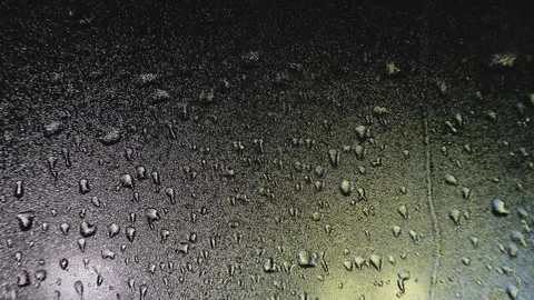 Drops of water flow down isolated on a black background, High quality 4K footage Vídeos de archivo 263184860