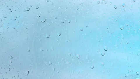 Drops of water flow down the transparent glass, rain falls on the window Stock Footage 166233046