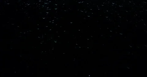 Drops of water flow through the dark glass Stock Footage 84269394