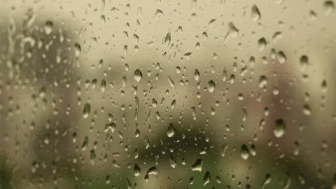 Drops of water flowing down glass during heavy rain. Cloudy summer weather. I Stock Footage 220795150