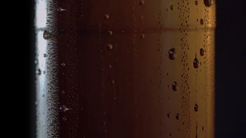 Drops of water flowing down on misted bottle Stock Footage 124292753