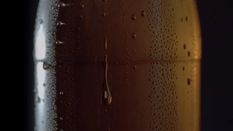 Drops of water flowing down on a misted bottle Stock Footage 124292760