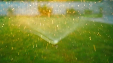 Drops of water fly against the background of the sunset in slow motion. Blurred Stock Footage 253788670