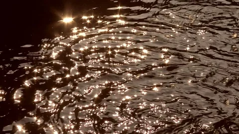 Drops of water on glittering lake surface Stock Footage 76757138