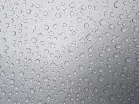 Drops of water on a gray background with light shading Stock Photos