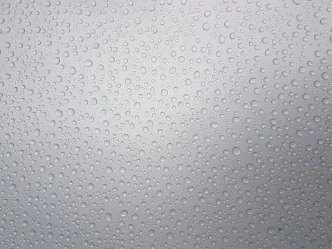 Drops of water on a gray background with light shading Фото