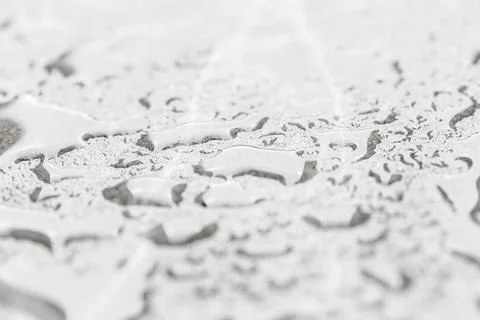 Drops of water on a gray background. Shallow depth of field. Selective focus. Stock Photos