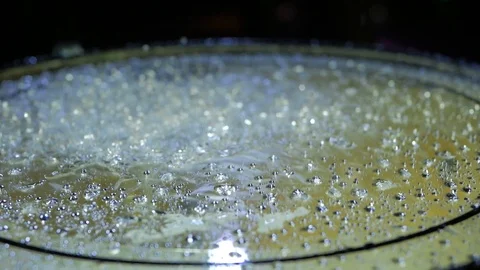 Drops water jumping on the drum on black background. Close up of drums perfused Stock Footage 121121048
