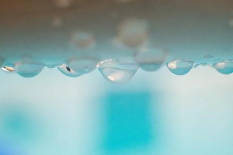 Drops of water on the poolside Stock Photos