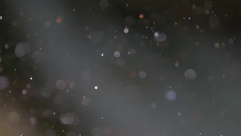 Drops of water scatter in the sun on dark blurred background in realtime 스톡 동영상 78046963