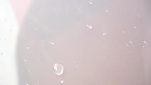 Drops water slide on the surface. Raindrops move on the glass. Drip condensate Stock Footage 230721066