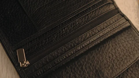 Drops of water splash onto a part of leather wallet. Waterproof and protection Stock Footage 126532174