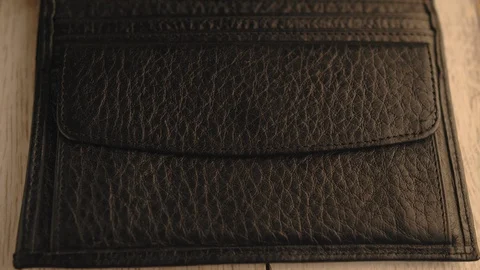 Drops of water splash onto a part of leather wallet. Waterproof and protection Stock Footage 126532340
